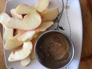 almond butter mixed with cricket powder on apples for healthy snack